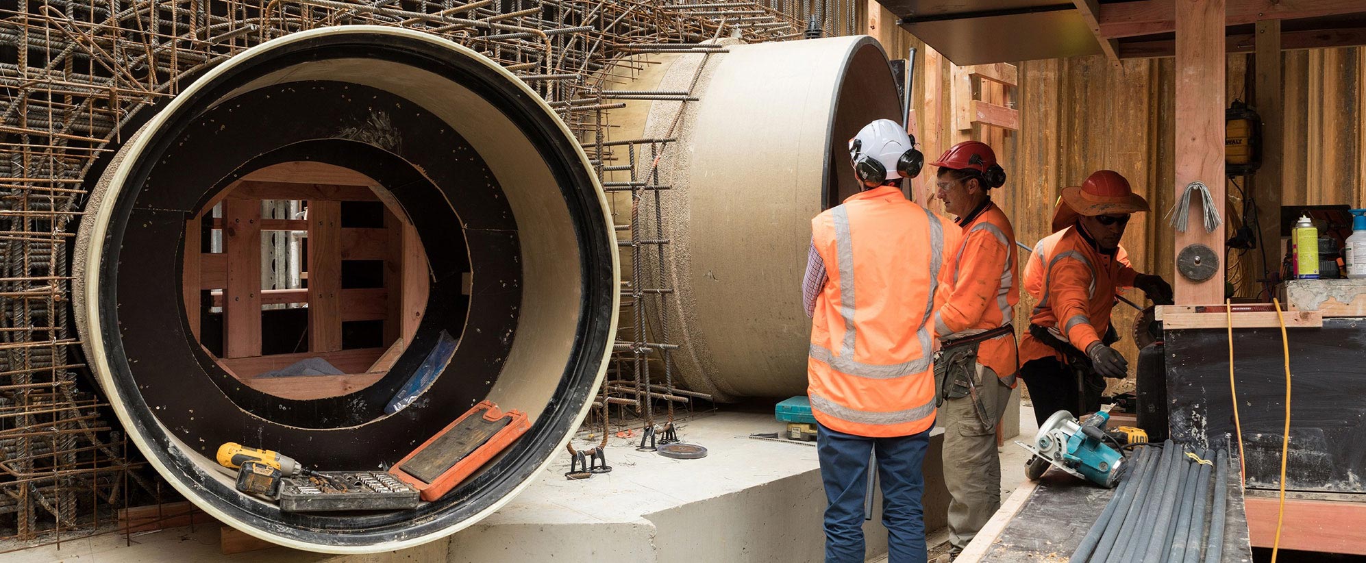 Workers standing with HOBAS pipe